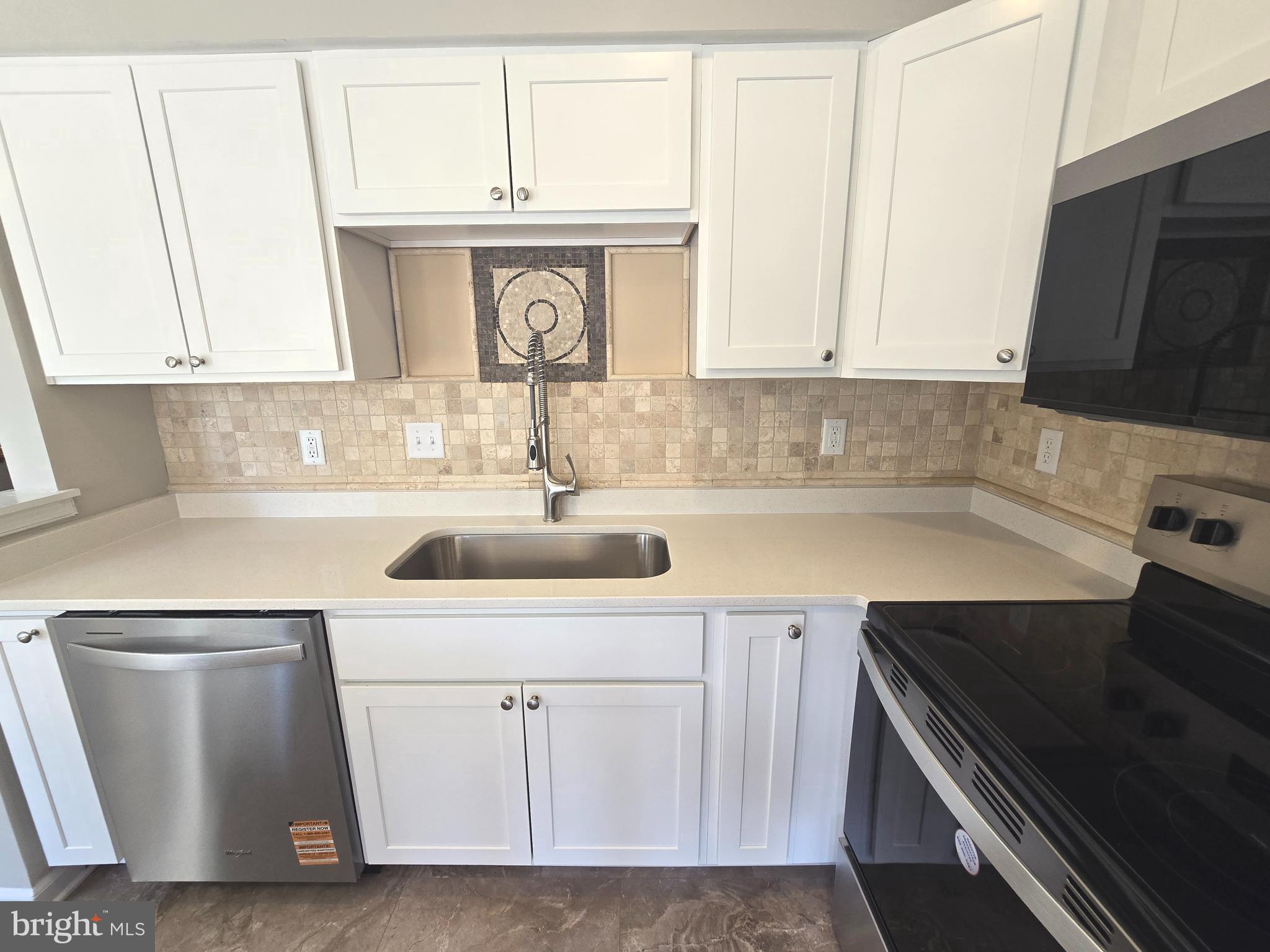 1248 Steed Street Ranson, WV 25438 - Photo 12 of 42 a kitchen with white cabinets sink and stove