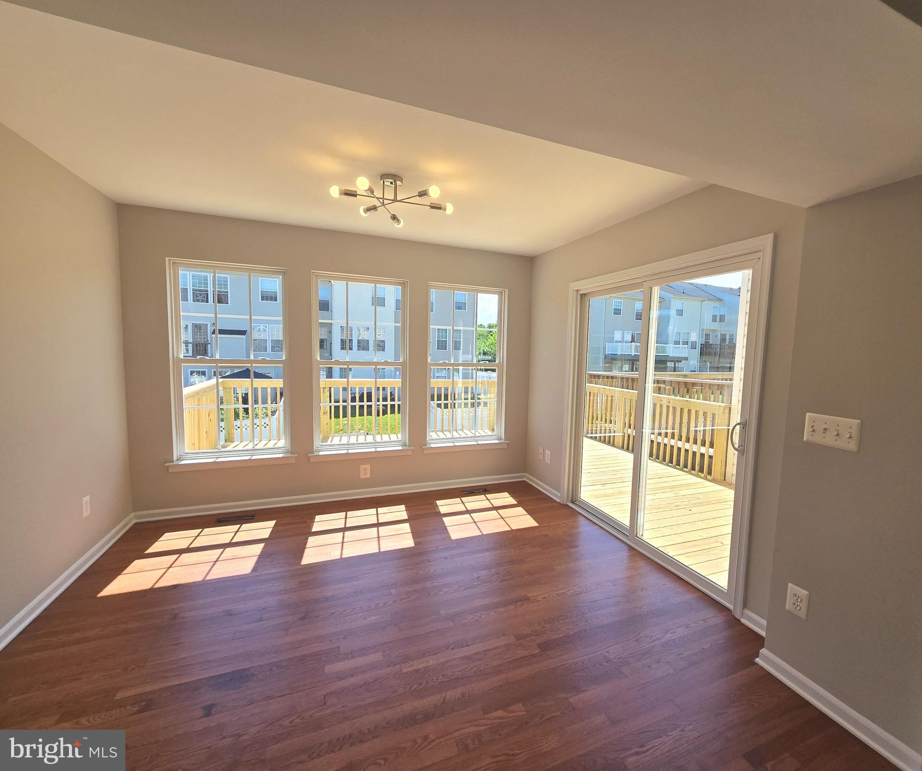 1248 Steed Street Ranson, WV 25438 - Photo 13 of 42 a view of an empty room with wooden floor and a window