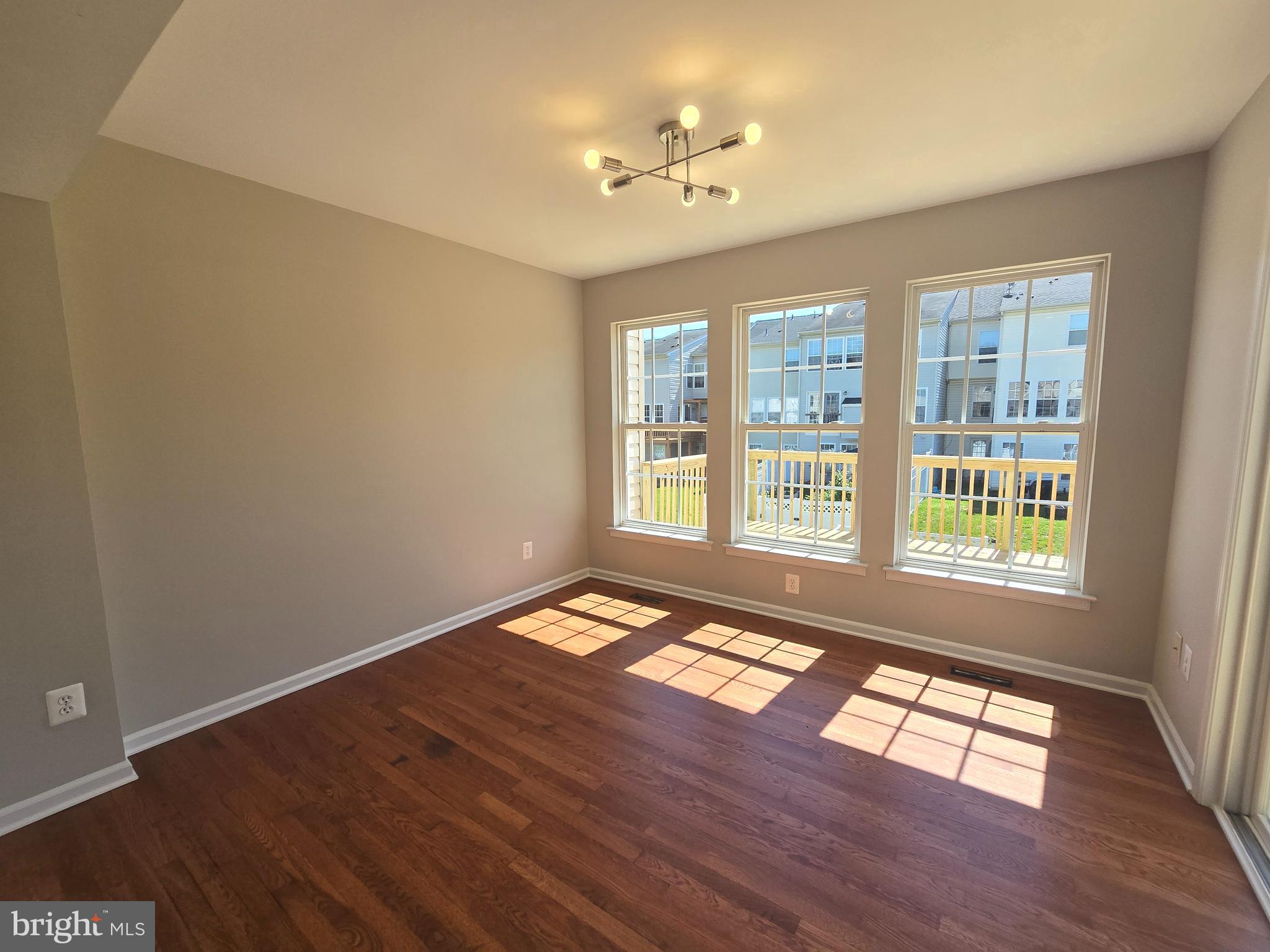 1248 Steed Street Ranson, WV 25438 - Photo 14 of 42 a view of an empty room with wooden floor and a window