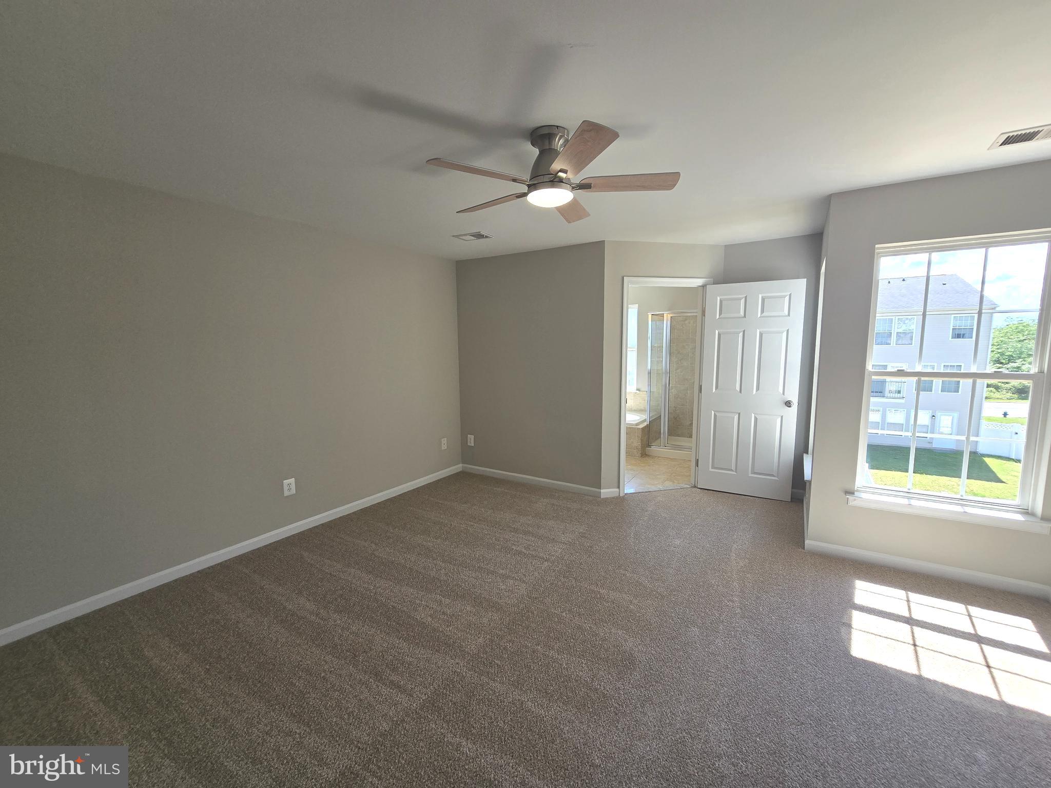 1248 Steed Street Ranson, WV 25438 - Photo 20 of 42 an empty room with windows and fan