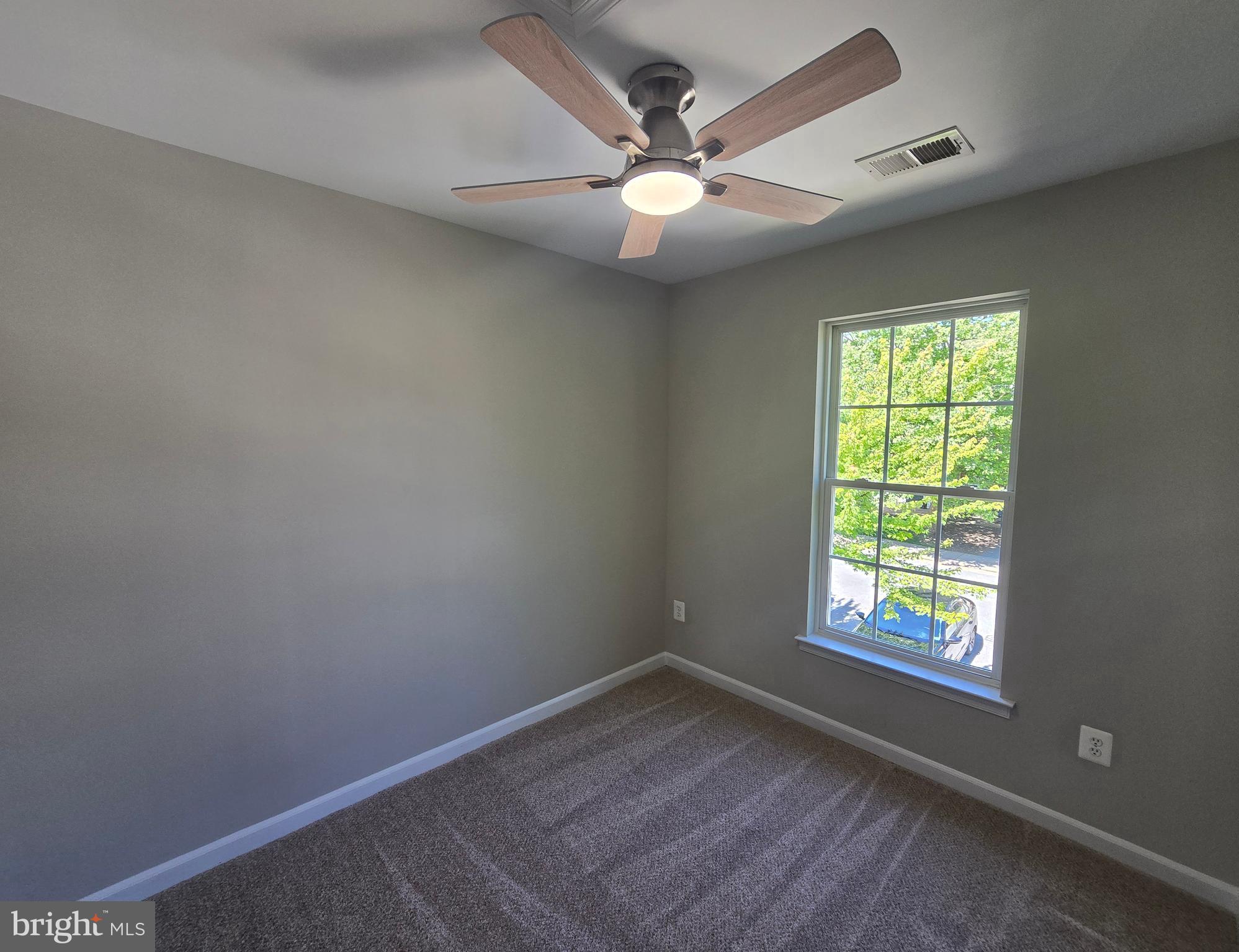 1248 Steed Street Ranson, WV 25438 - Photo 30 of 42 an empty room with a window and a fan
