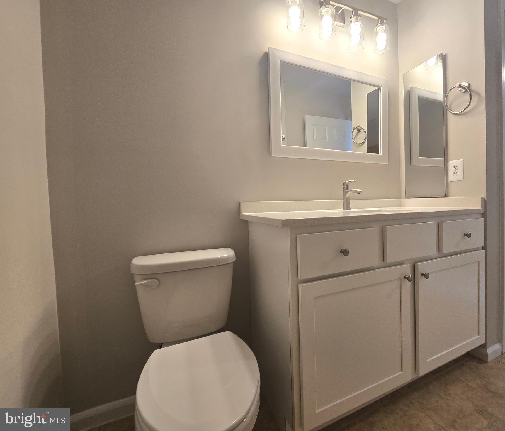 1248 Steed Street Ranson, WV 25438 - Photo 32 of 42 a bathroom with a toilet sink vanity and mirror