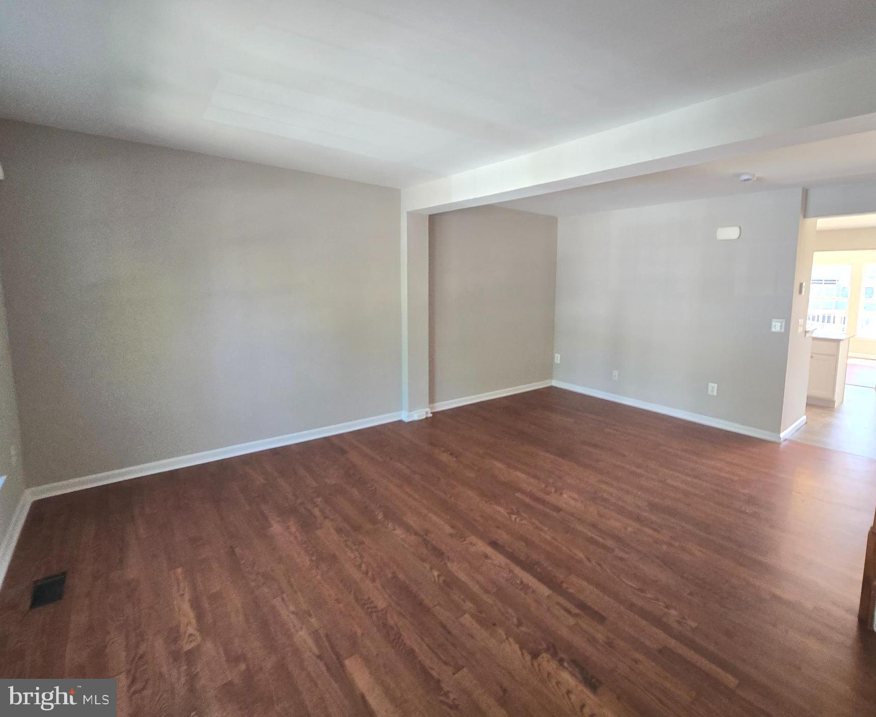 1248 Steed Street Ranson, WV 25438 - Photo 5 of 42 a view of an empty room with wooden floor and a window