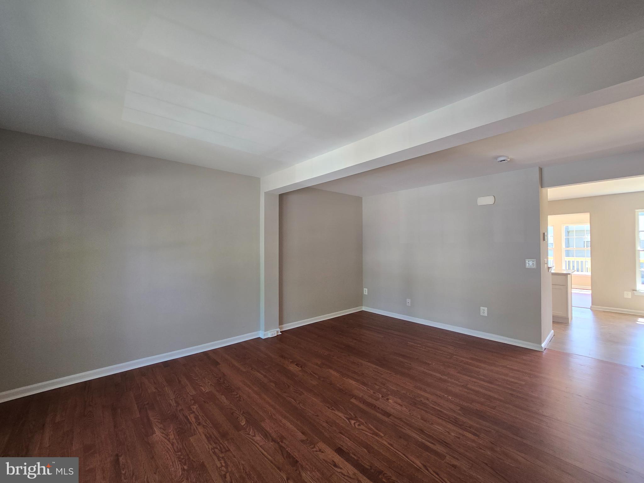 1248 Steed Street Ranson, WV 25438 - Photo 6 of 42 a view of an empty room with wooden floor and a window