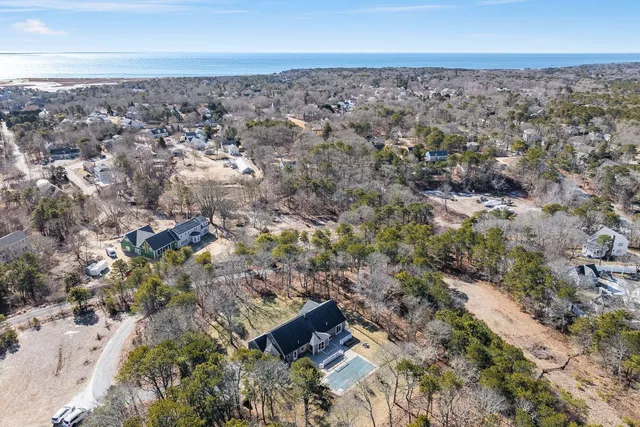 an aerial view of house with yard and mountain view in back
