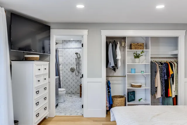 a living room with closet and a flat screen tv