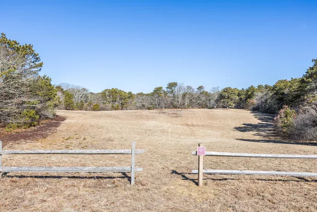 a view of a house with a yard covered in snow