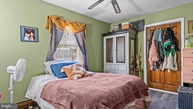 a bedroom with a bed and a window