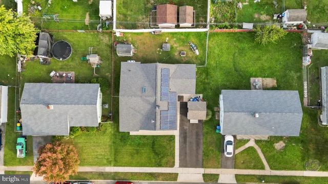 an aerial view of a house with a garden and houses