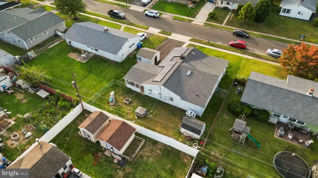an aerial view of a house with a garden and trees