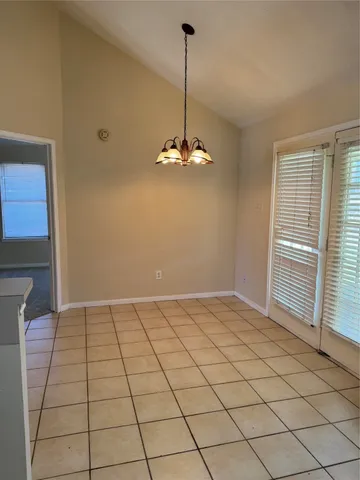 a view of a livingroom with a chandelier fan and window