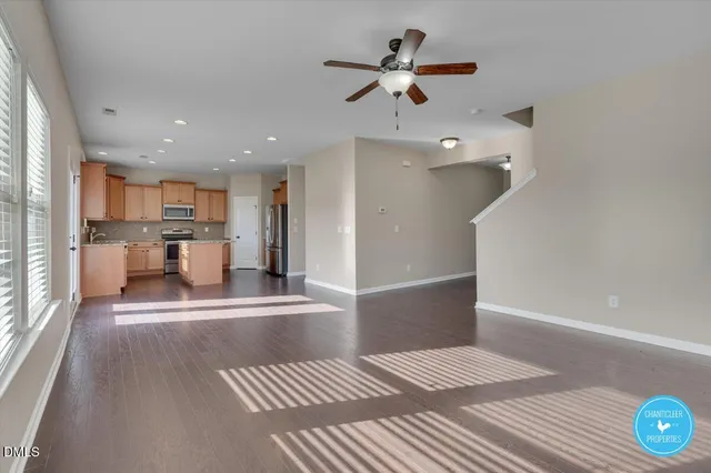 a view of a living room a ceiling fan and window