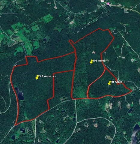 a view of a yard with wooden fence