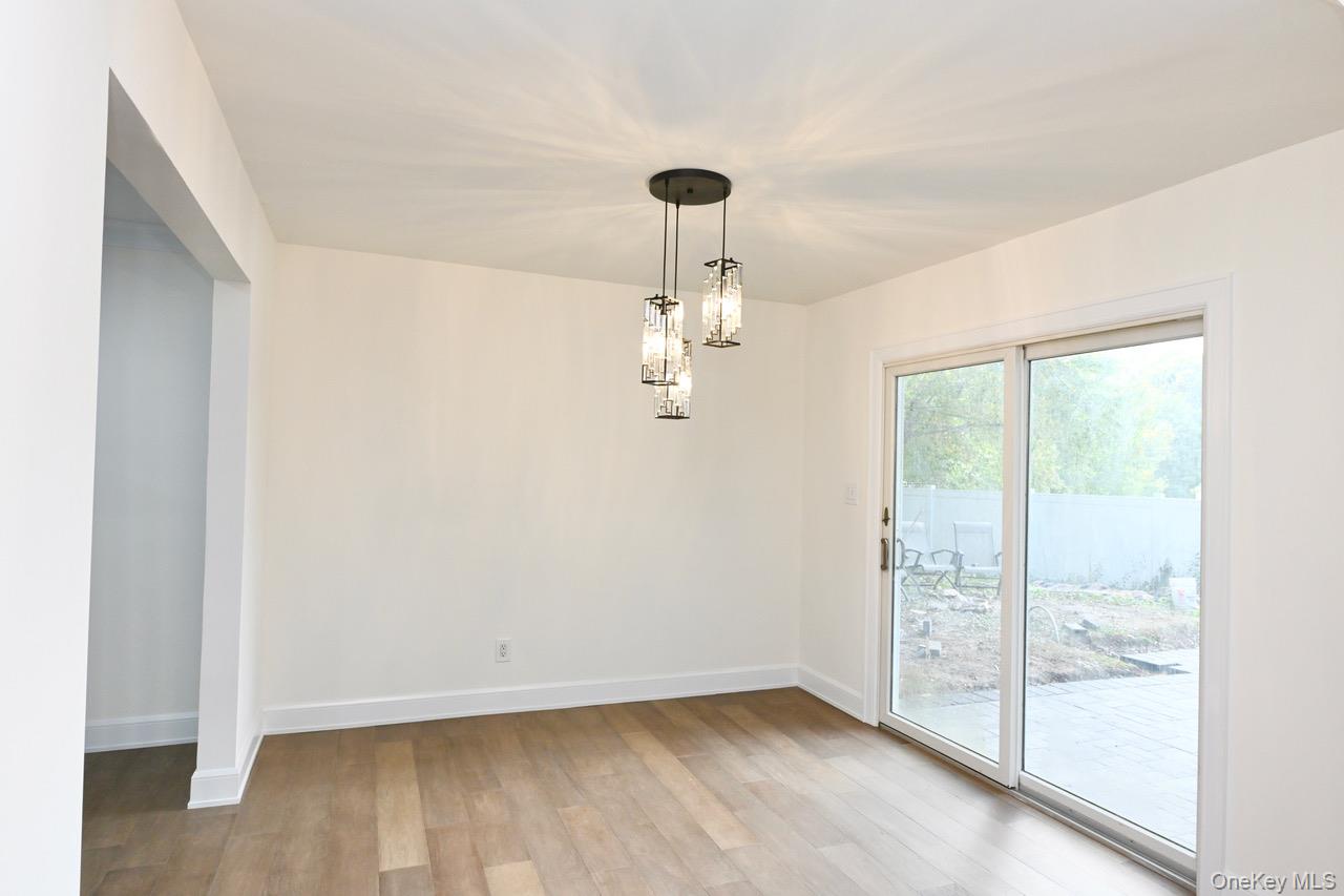 2 Little Hill East Setauket, NY 11733 - Photo 12 of 22 a view of empty room with wooden floor and fan