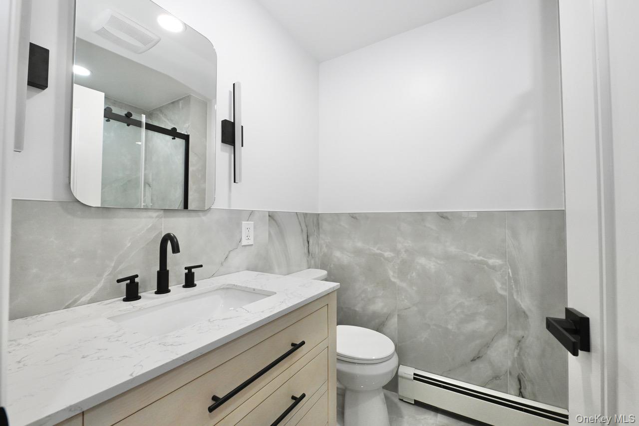 2 Little Hill East Setauket, NY 11733 - Photo 13 of 22 a bathroom with a sink a toilet and mirror