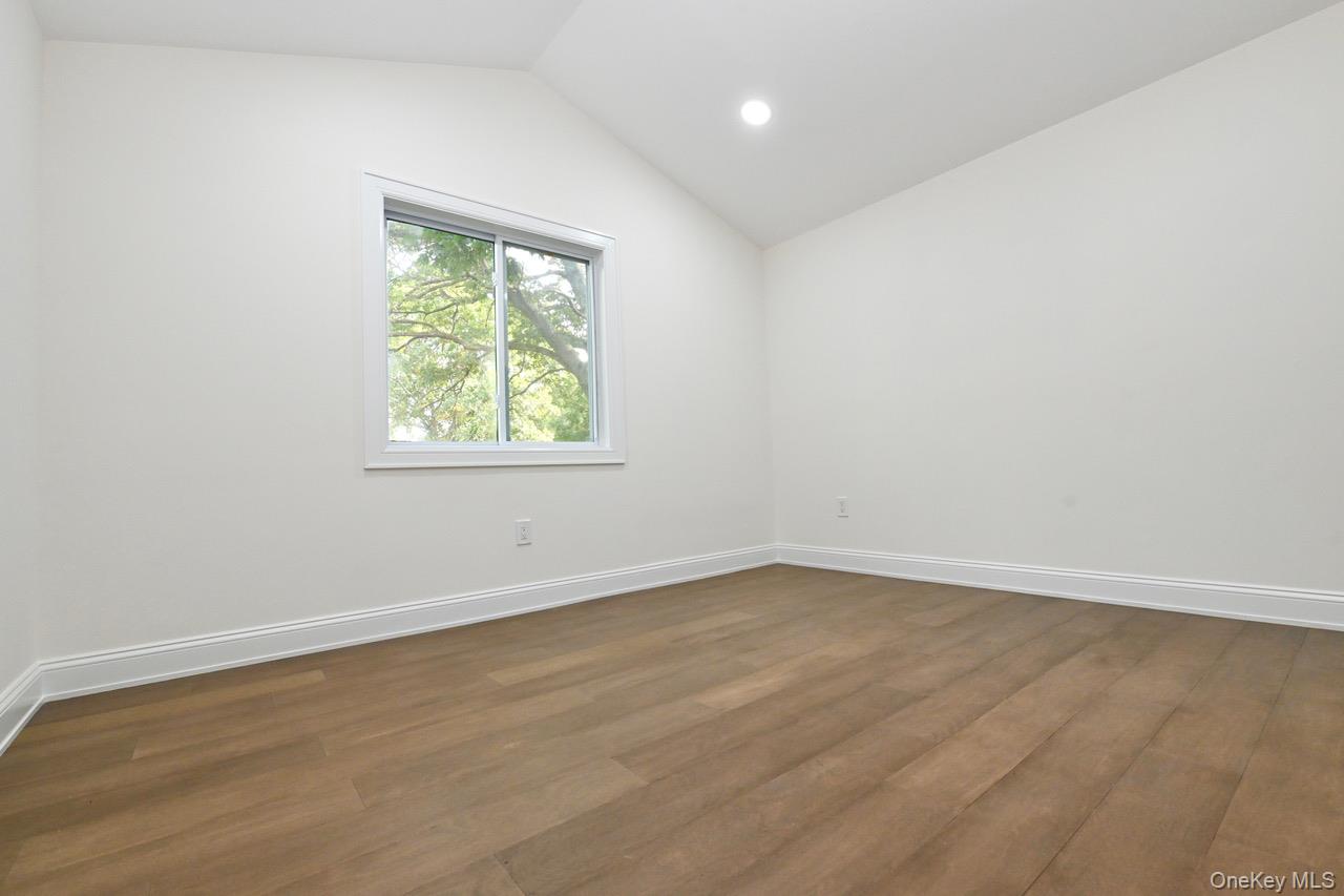 2 Little Hill East Setauket, NY 11733 - Photo 17 of 22 an empty room with wooden floor and windows