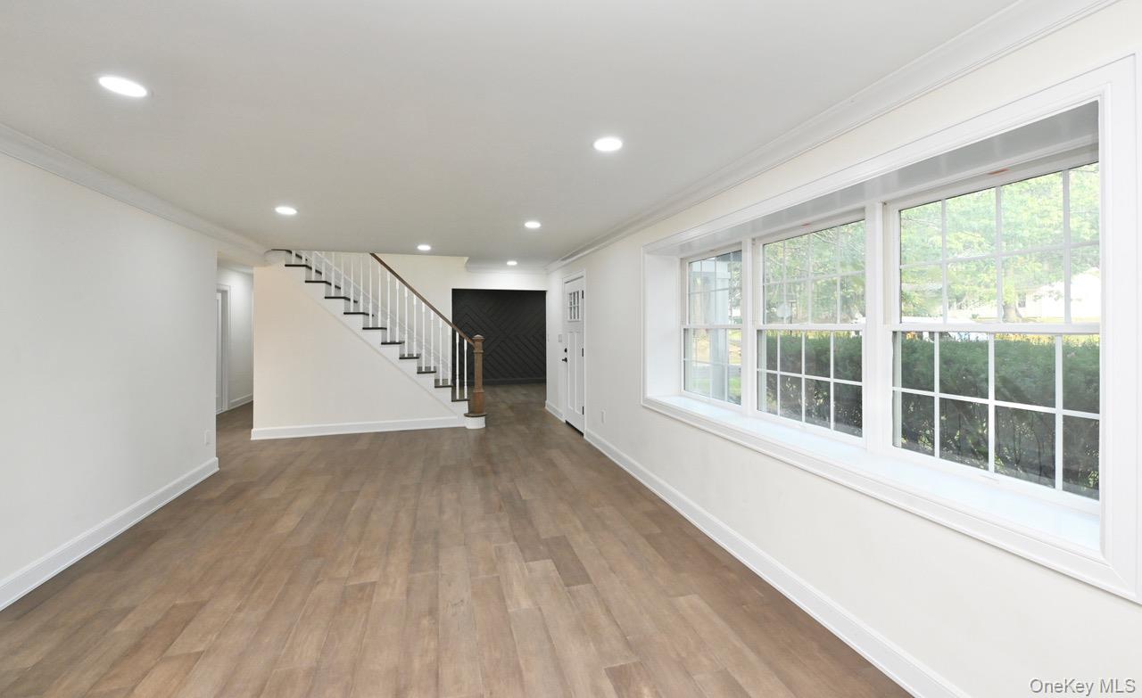 2 Little Hill East Setauket, NY 11733 - Photo 6 of 22 a view of an empty room with wooden floor and a window
