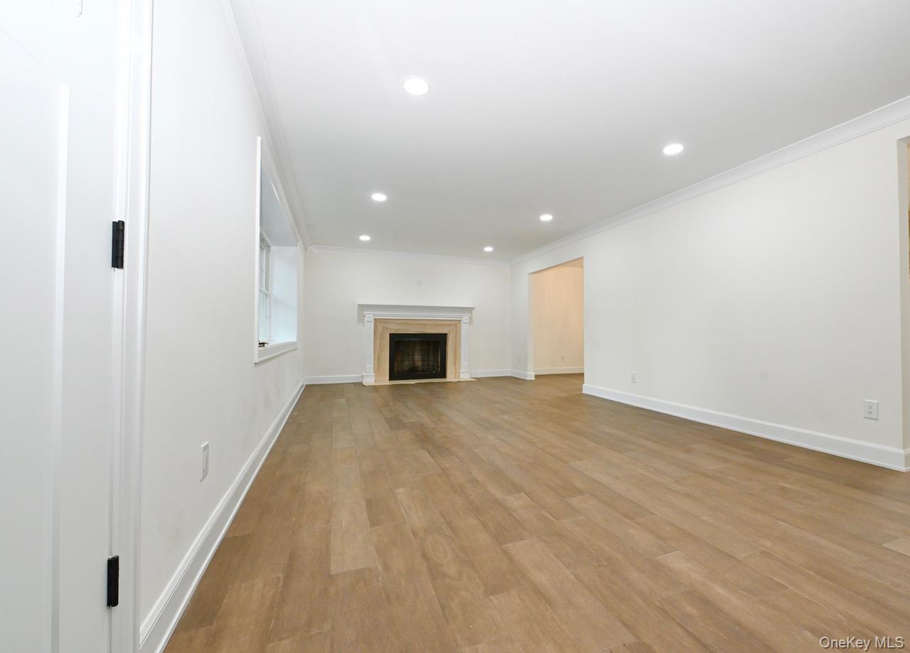 2 Little Hill East Setauket, NY 11733 - Photo 7 of 22 a view of empty room with wooden floor and fireplace