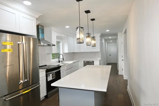 a view of a kitchen with electric appliances
