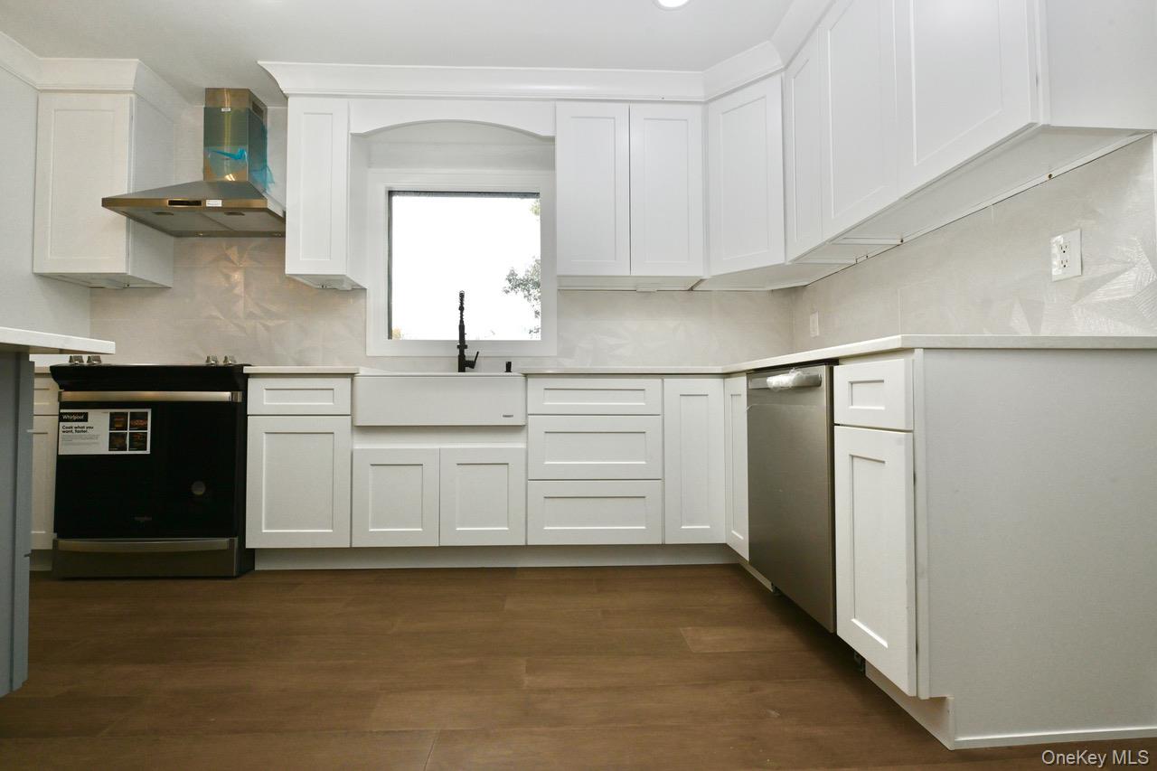 2 Little Hill East Setauket, NY 11733 - Photo 10 of 22 a kitchen with stainless steel appliances a refrigerator and cabinets