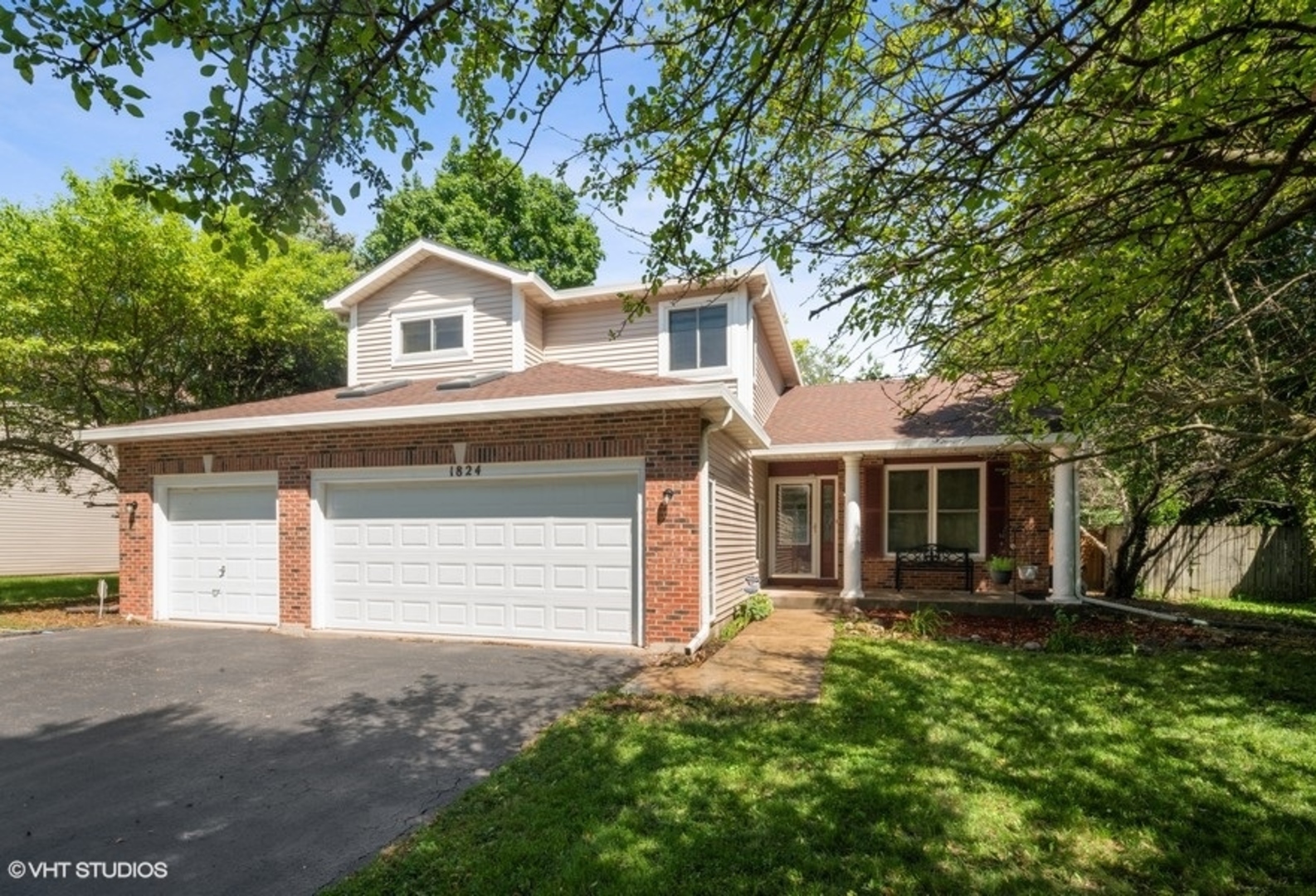 1824 Red Bud Road Bolingbrook, IL 60490 - Photo 1 of 22 a front view of a house with a yard and garage