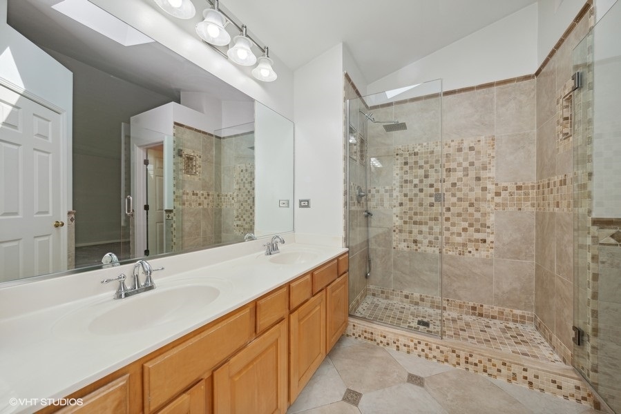 1824 Red Bud Road Bolingbrook, IL 60490 - Photo 14 of 22 a bathroom with a double vanity sink mirror double shower and a bathtub