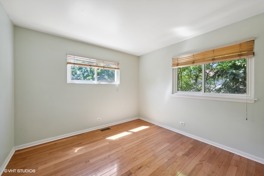 1824 Red Bud Road Bolingbrook, IL 60490 - Photo 17 of 22 a view of empty room with wooden floor and fan