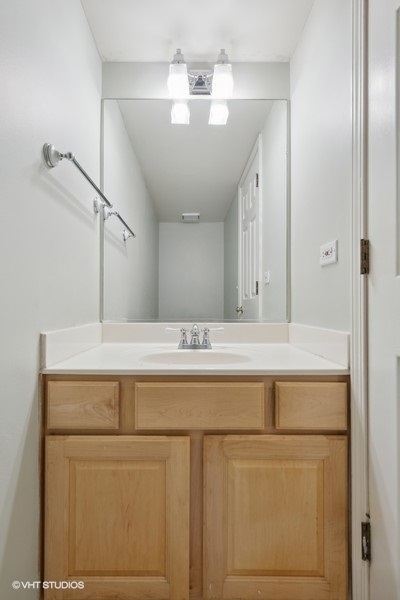 1824 Red Bud Road Bolingbrook, IL 60490 - Photo 20 of 22 a bathroom with a sink and a mirror