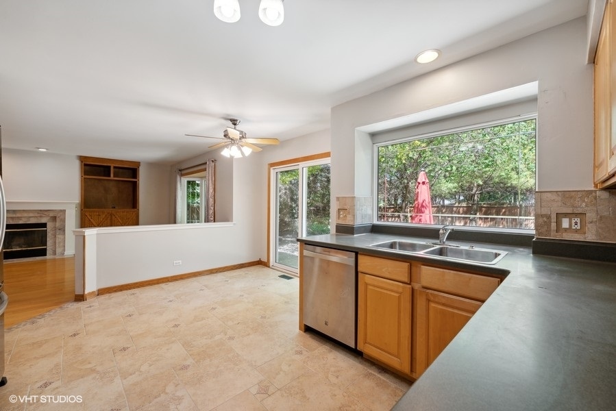 1824 Red Bud Road Bolingbrook, IL 60490 - Photo 7 of 22 a view of a kitchen with kitchen island a large window cabinets a sink and appliances
