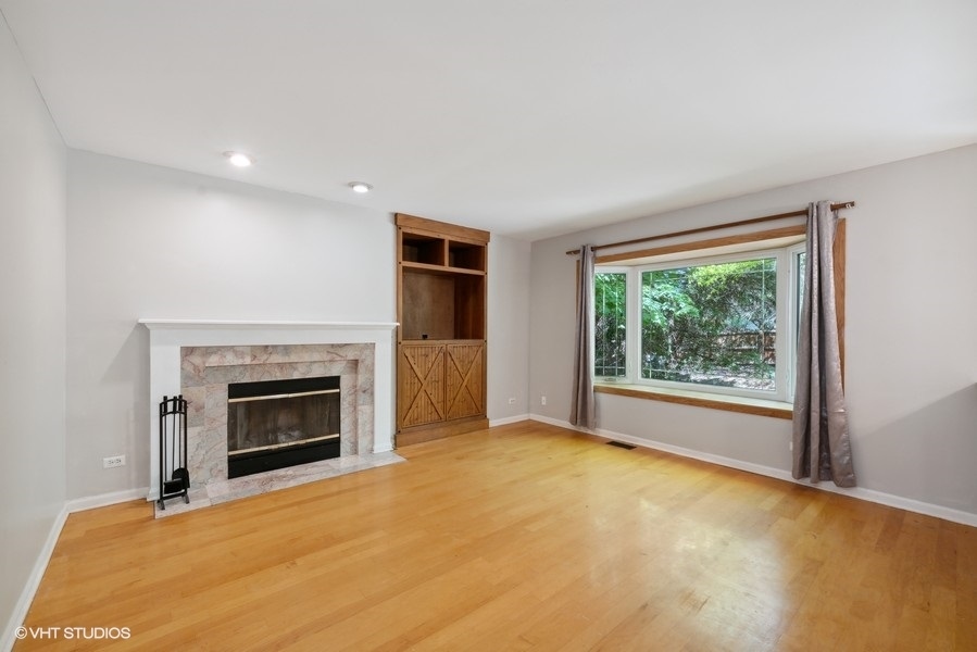 1824 Red Bud Road Bolingbrook, IL 60490 - Photo 8 of 22 a view of empty room with a fireplace and window