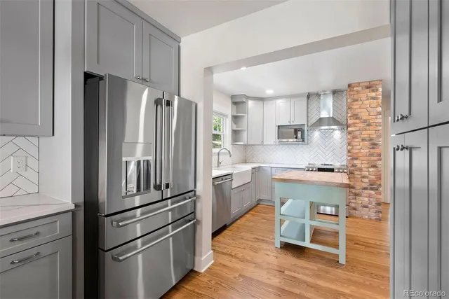 a kitchen with stainless steel appliances a refrigerator sink and cabinets