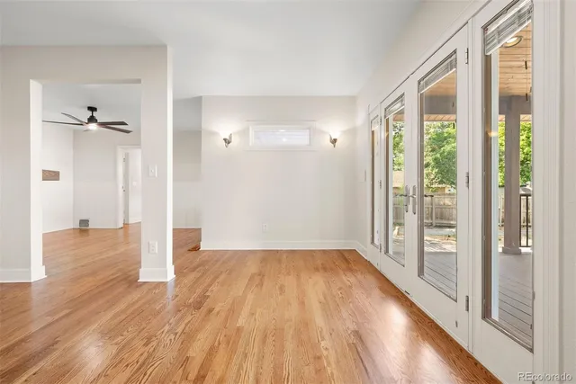 a view of an empty room with wooden floor