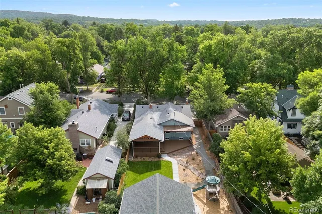 a living room with furniture fireplace and a large window