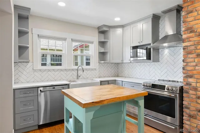 a dining room with furniture a rug and wooden floor