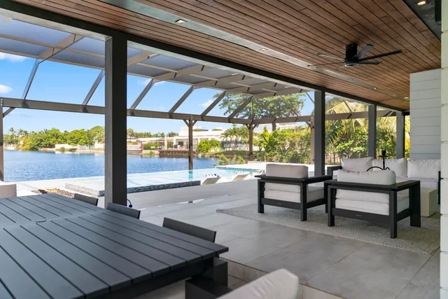 a view of a patio with a table chairs and wooden floor