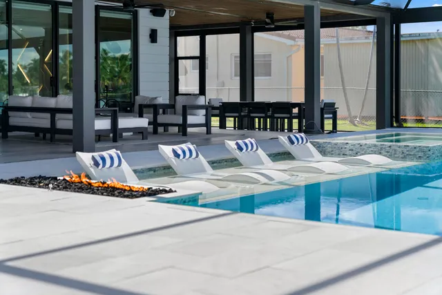 a view of swimming pool with outdoor seating and window