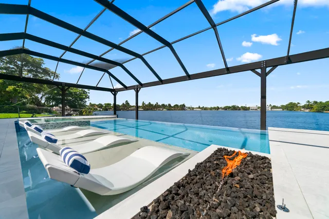 a roof deck with table and chairs under an umbrella