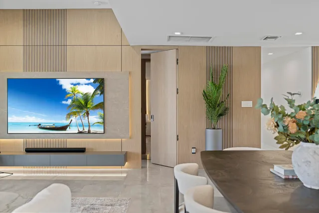 a living room with furniture and a potted plant