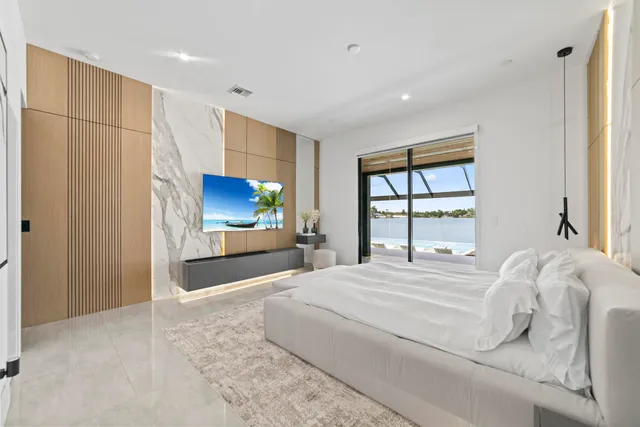 a bedroom with a bed and a flat screen tv