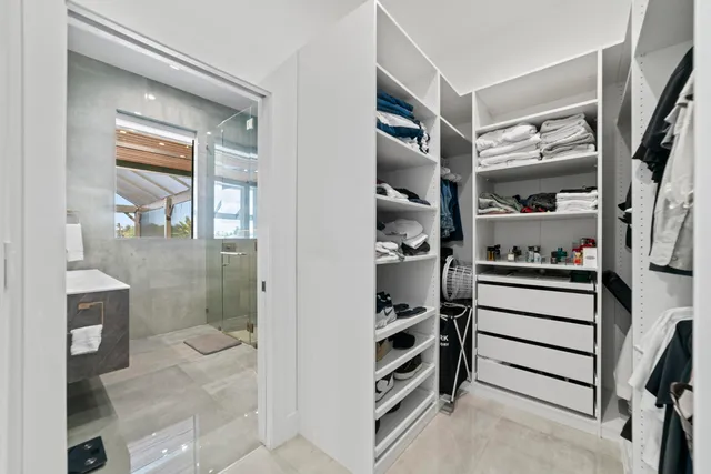 a view of walk in closet and bedroom