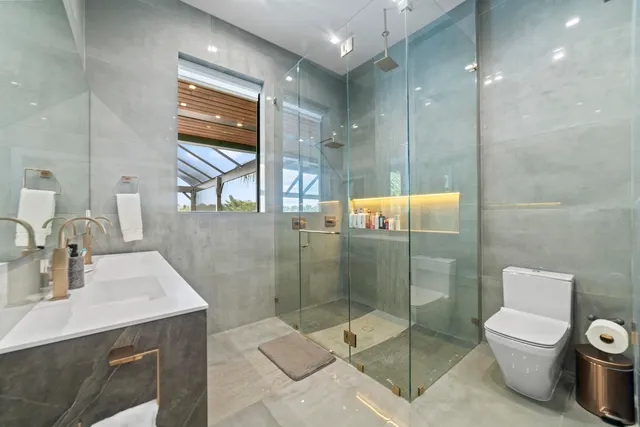 a bathroom with a toilet sink and shower