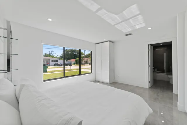 a room with a bed and a large window