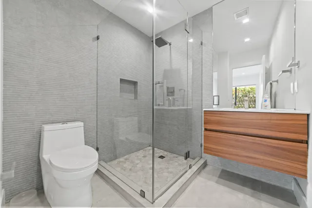 a bathroom with a toilet and a shower