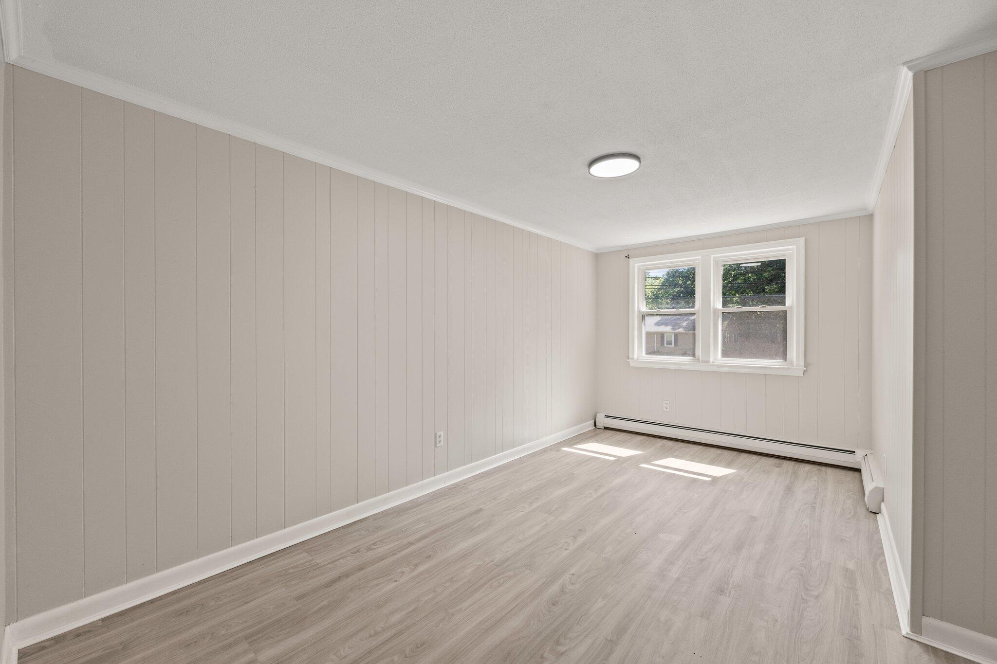 87 Fuller Road Centerville, MA 02632 - Photo 11 of 33 an empty room with wooden floor and windows