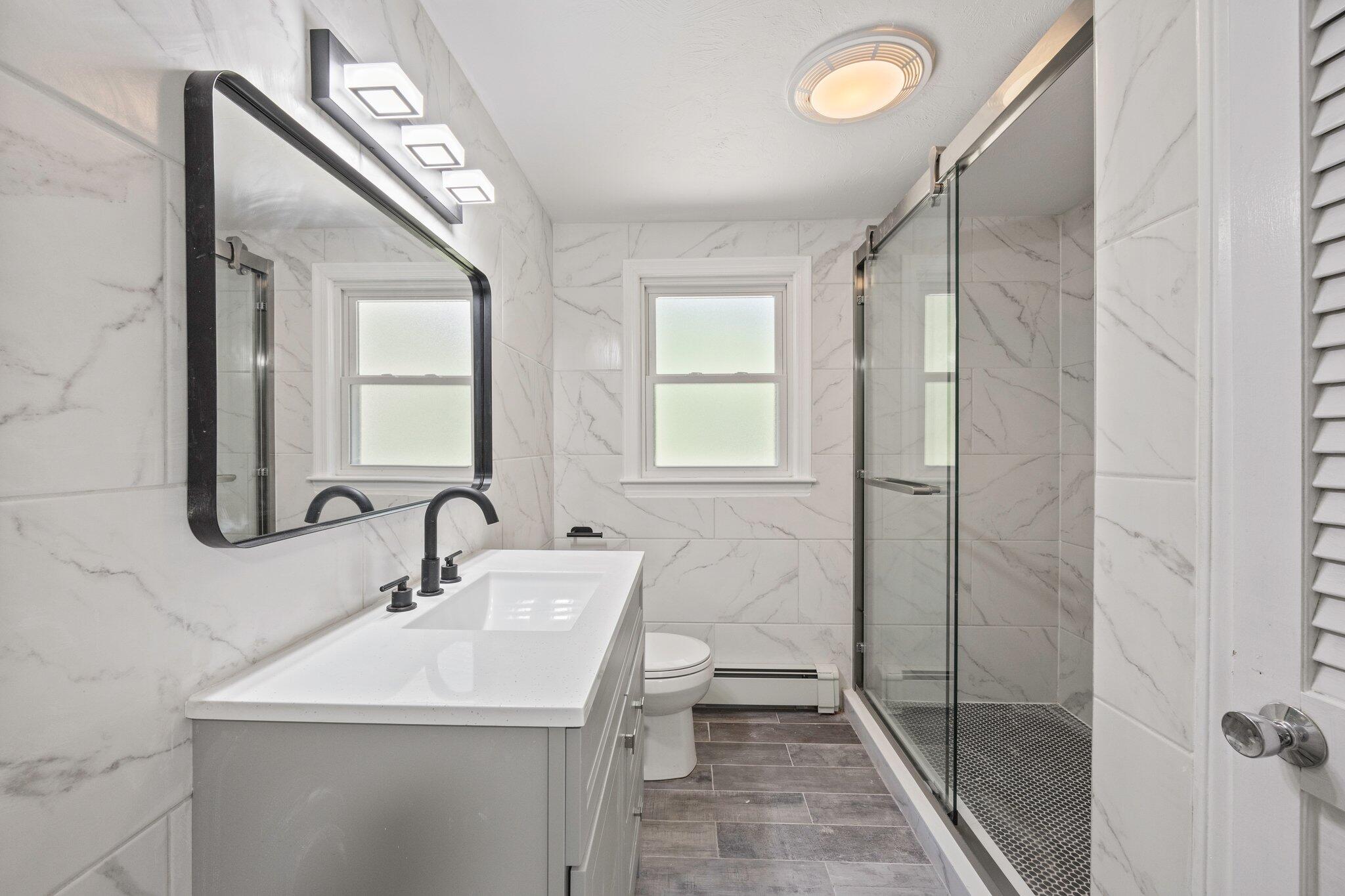 87 Fuller Road Centerville, MA 02632 - Photo 13 of 33 a bathroom with a sink a toilet and shower
