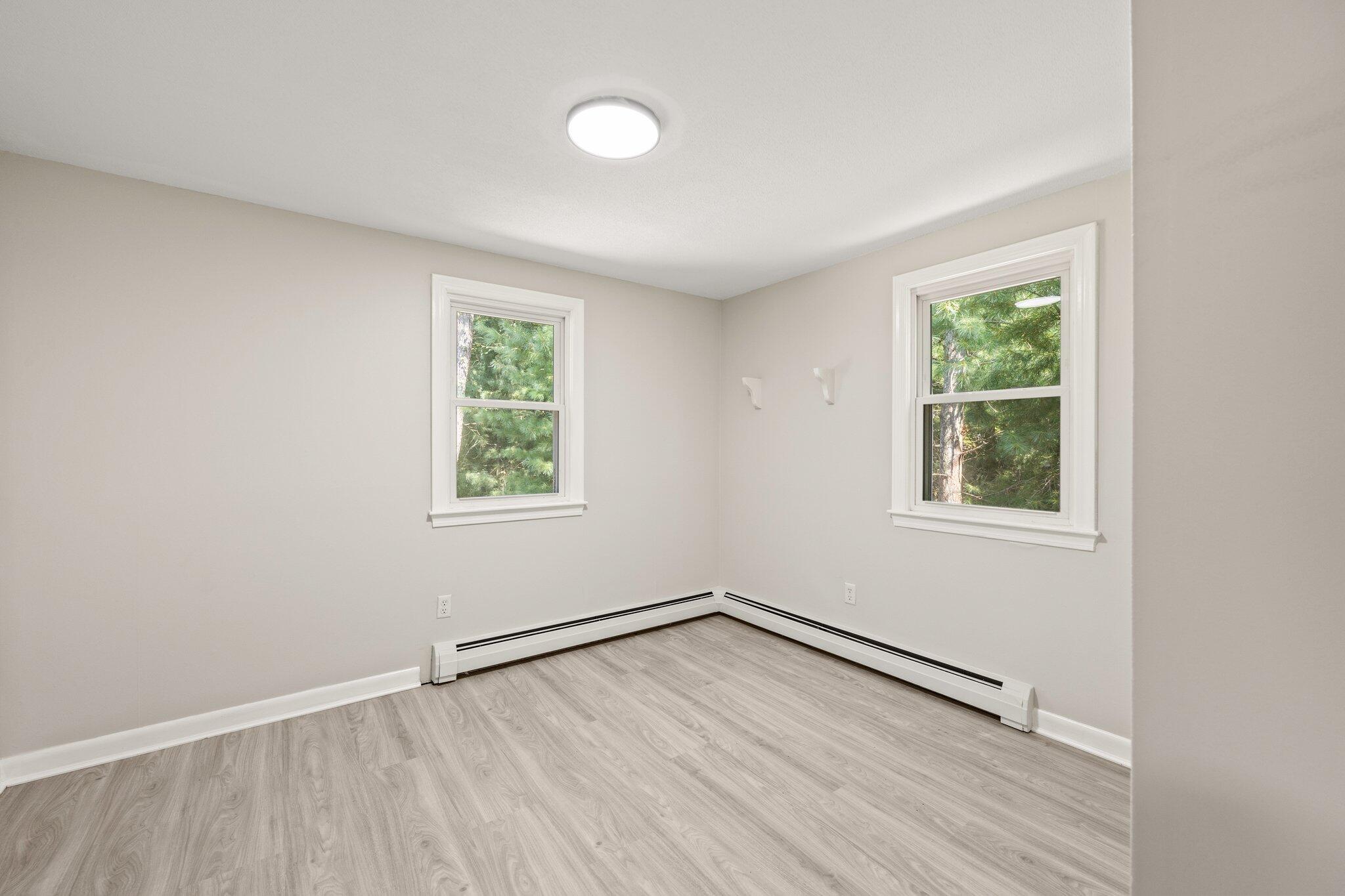 87 Fuller Road Centerville, MA 02632 - Photo 17 of 33 an empty room with wooden floor and windows