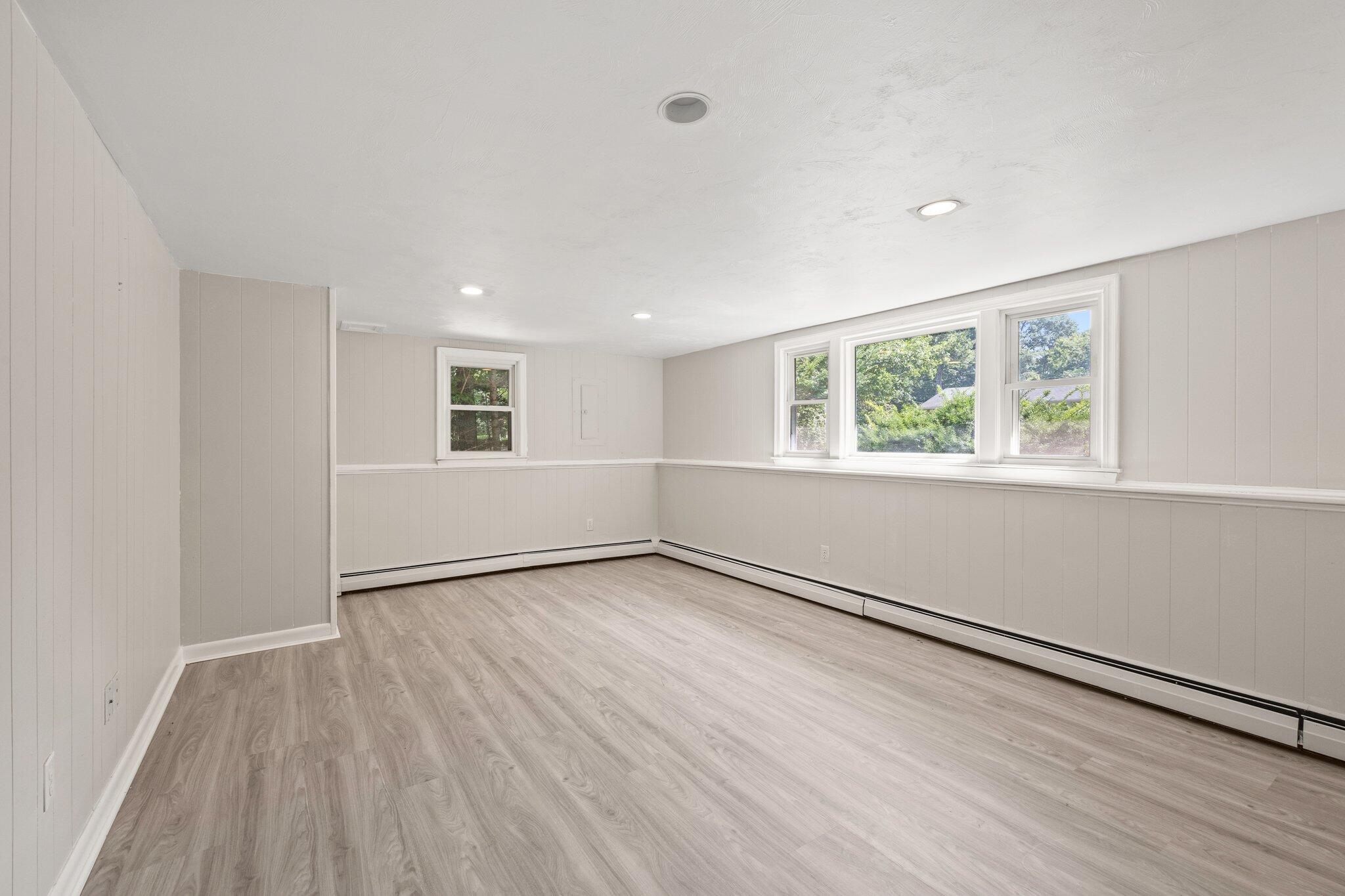 87 Fuller Road Centerville, MA 02632 - Photo 20 of 33 an empty room with wooden floor and windows