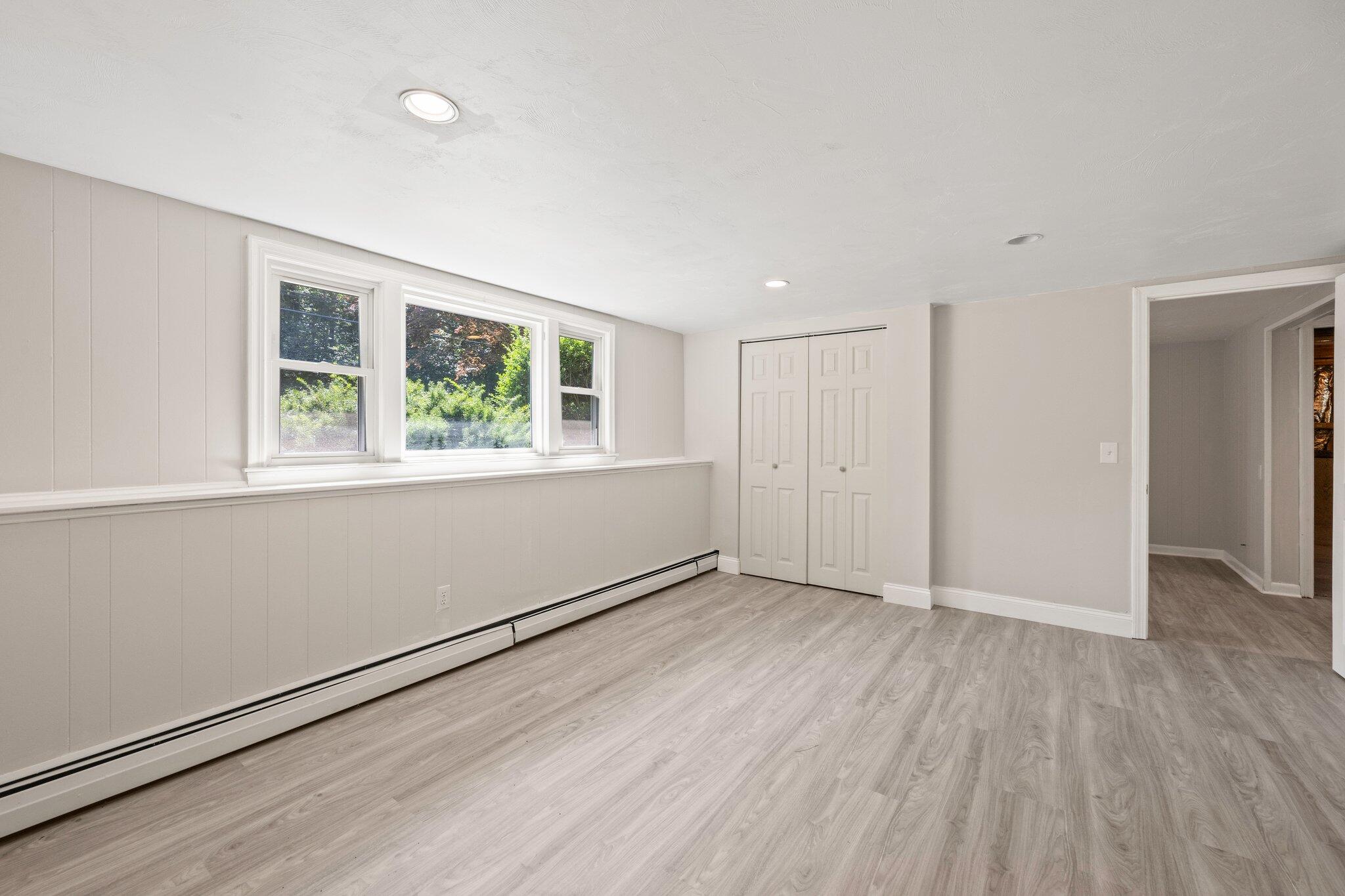 87 Fuller Road Centerville, MA 02632 - Photo 21 of 33 a view of an empty room with wooden floor and a window