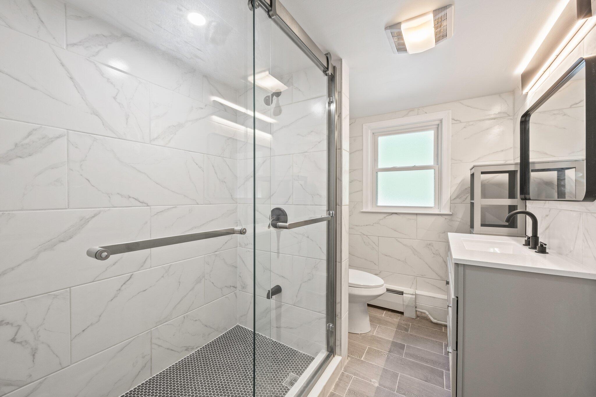 87 Fuller Road Centerville, MA 02632 - Photo 22 of 33 a bathroom with a granite countertop sink toilet and shower