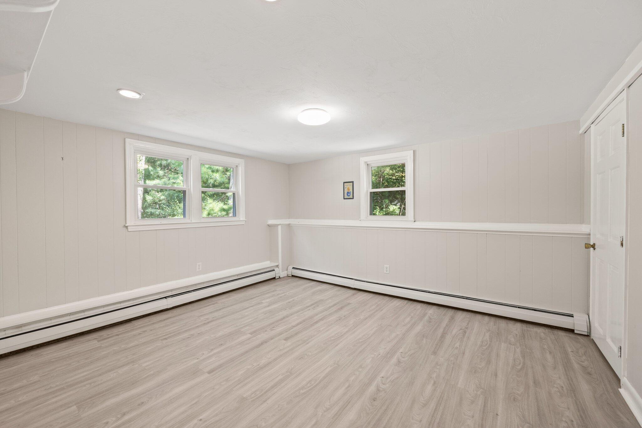 87 Fuller Road Centerville, MA 02632 - Photo 23 of 33 an empty room with wooden floor and windows